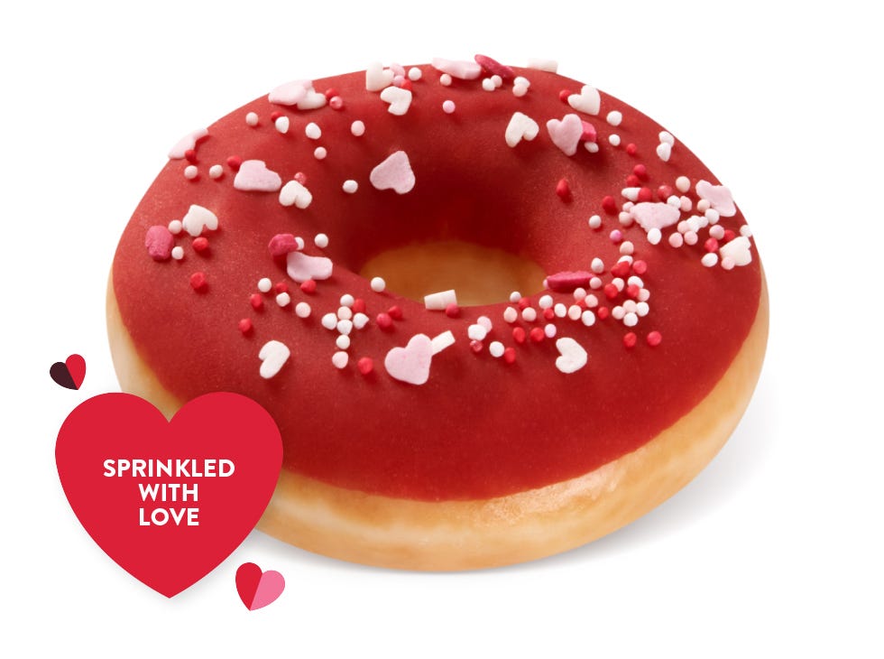 Raspberry Choc Escape Picture of Raspberry Chocolate Valentine's Day doughnut, with a chocolate cip and red raspberry drizzle on top